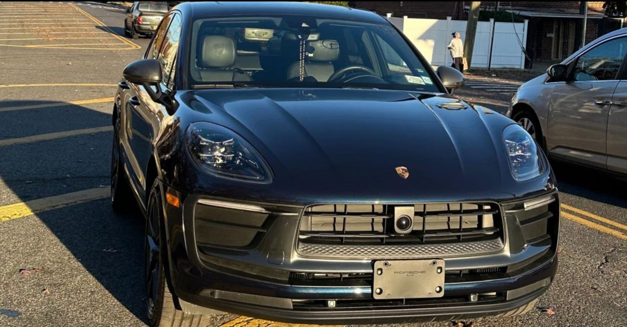 Dark blue Porsche Macan after front-end collision repair at Universe Auto Body in the Bronx