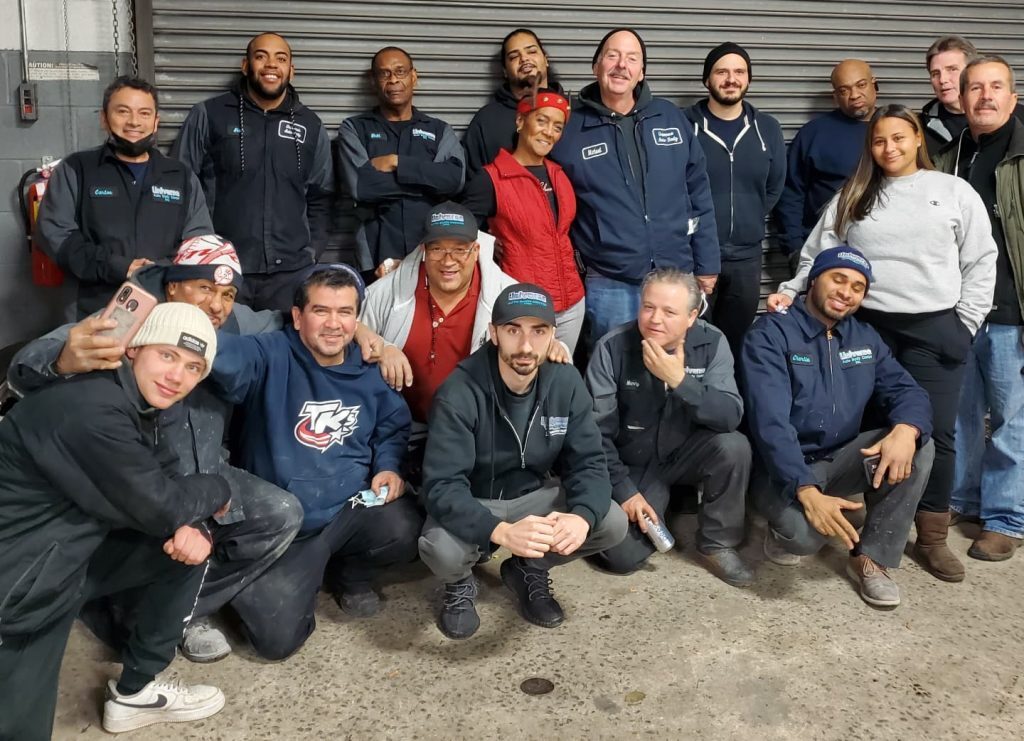 The Universe Auto Body team outside the shop on Givan Avenue in the Bronx